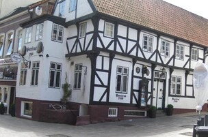 A traditional half-timbered building with a sign reading "Porticus 1740".