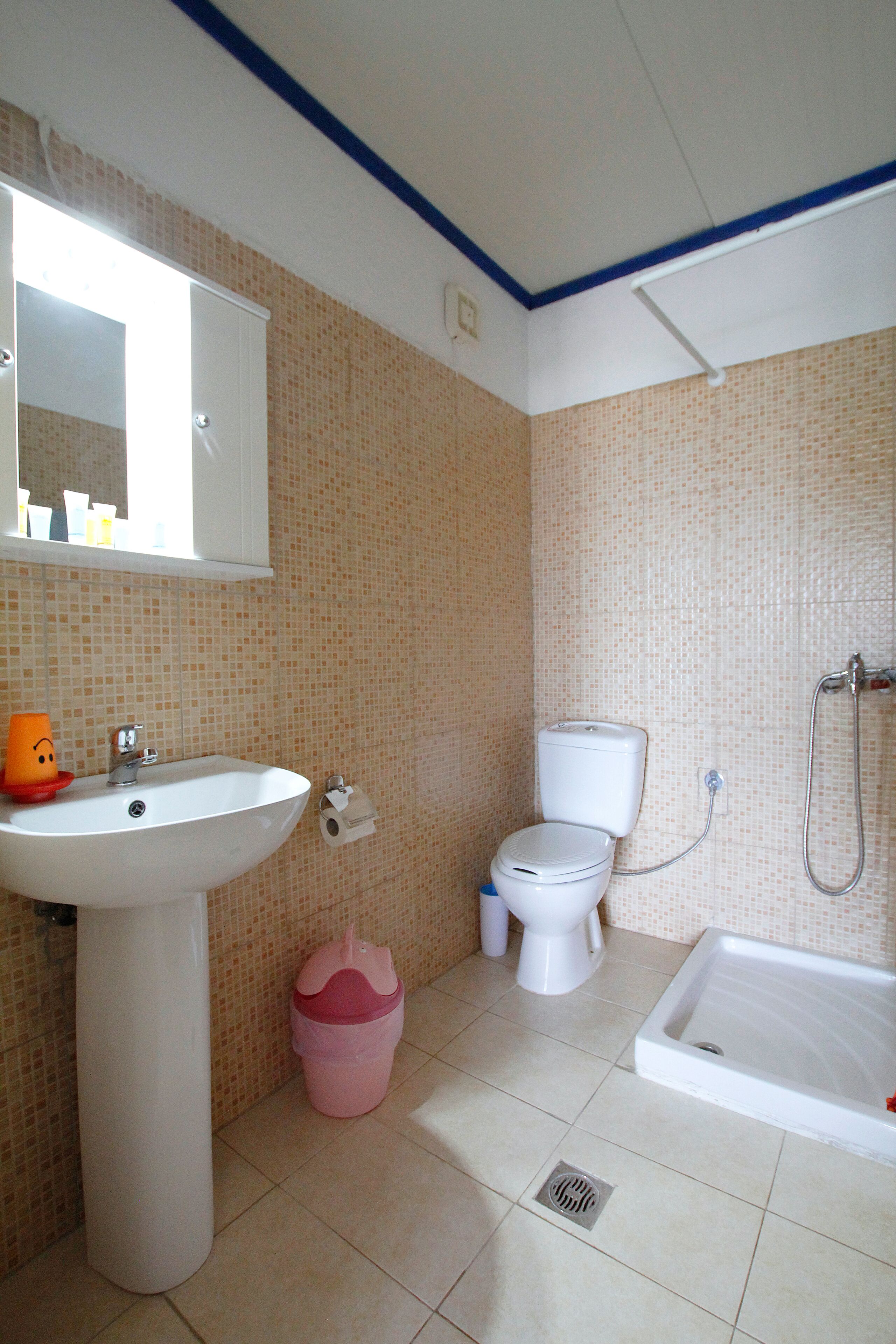 A bathroom with a sink, toilet, and bathtub.