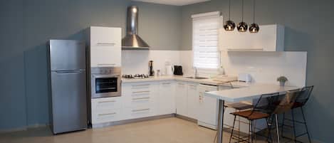Deluxe Apartment, 2 Bedrooms | Private kitchen | Full-size fridge, microwave, coffee/tea maker, electric kettle