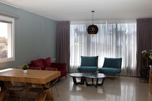 Deluxe Apartment, 2 Bedrooms | Living room | 32-inch flat-screen TV with cable channels, TV