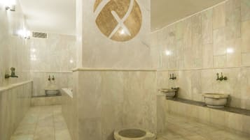 Features a large logo, sinks, and a central toilet.