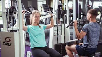 A gym with exercise equipment, including a Cybex machine.