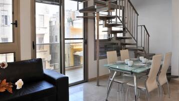 Duplex, 3 Bedrooms | Living room | 32-inch TV with satellite channels