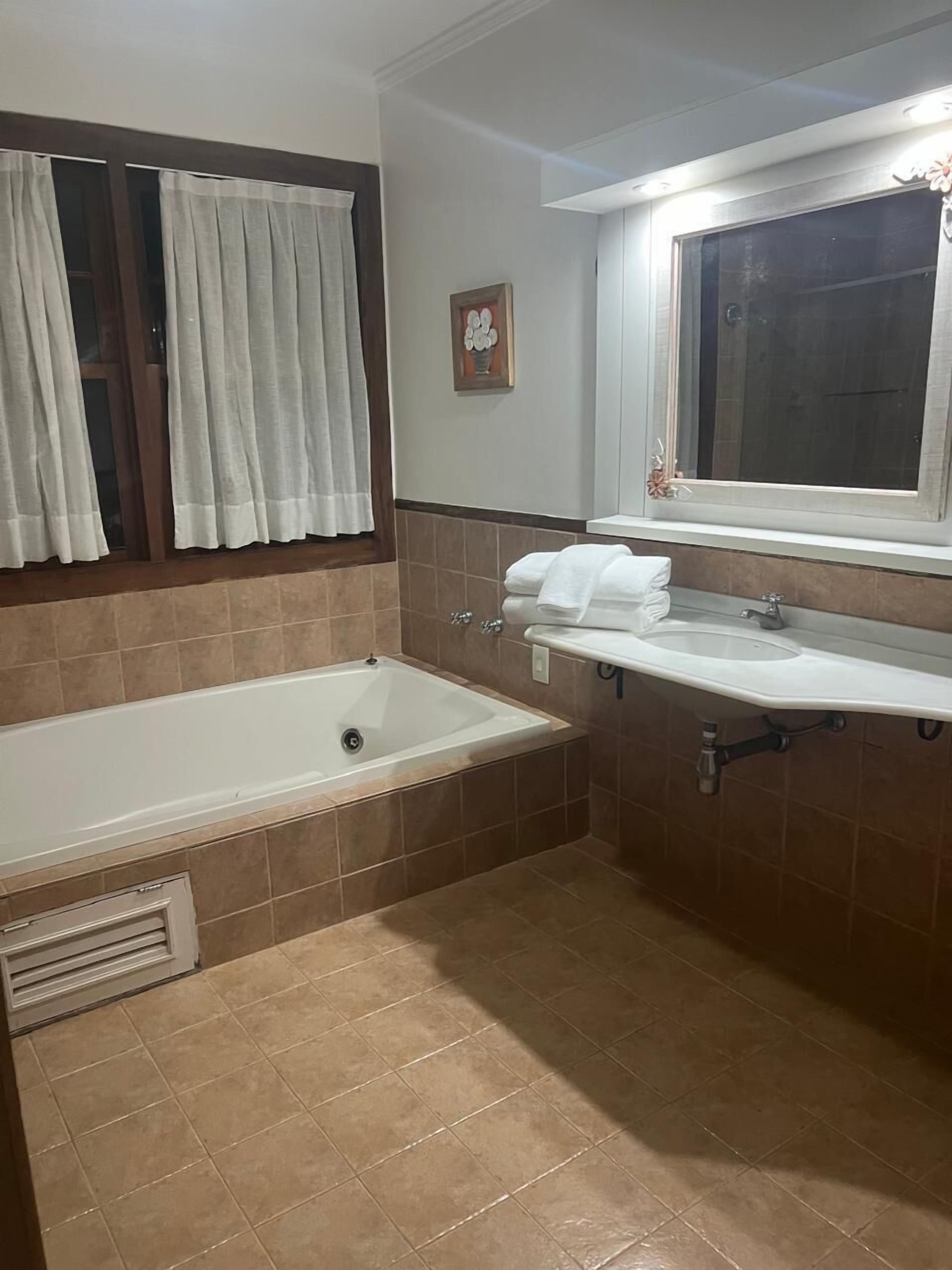 superior room, jetted tub | bathroom | shower, hair dryer, towels