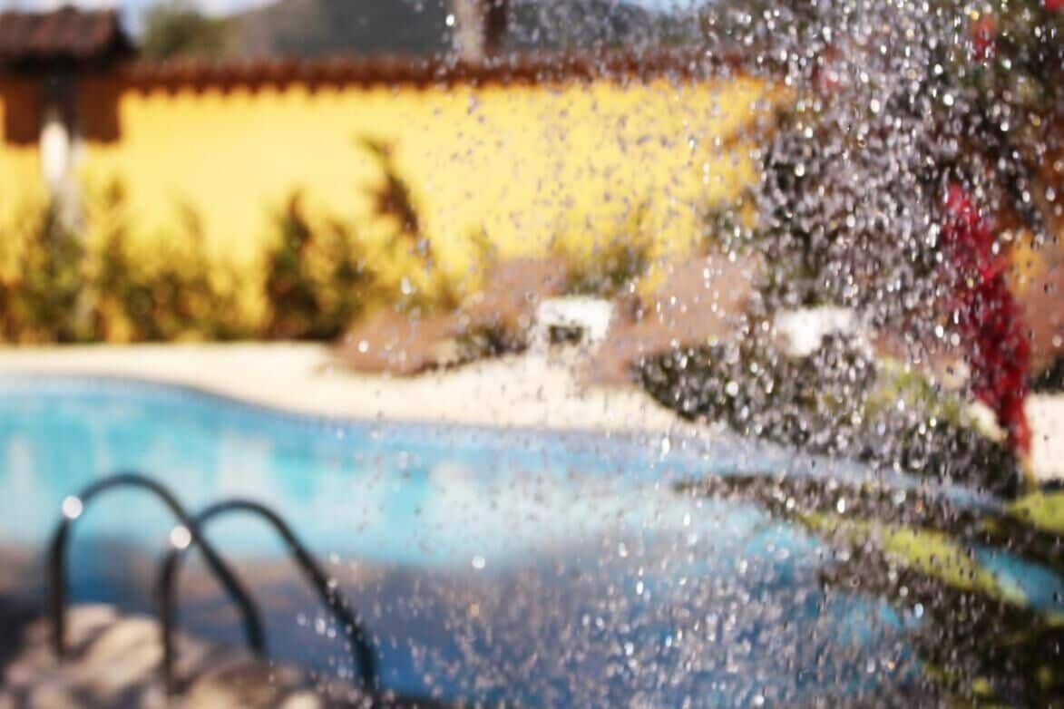 A swimming pool with a clear water surface and a visible edge.