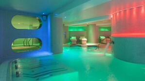 An indoor swimming pool with a modern design, featuring a large circular structure and two oval windows. - Hotel Ambassador Playa II (Benidorm)