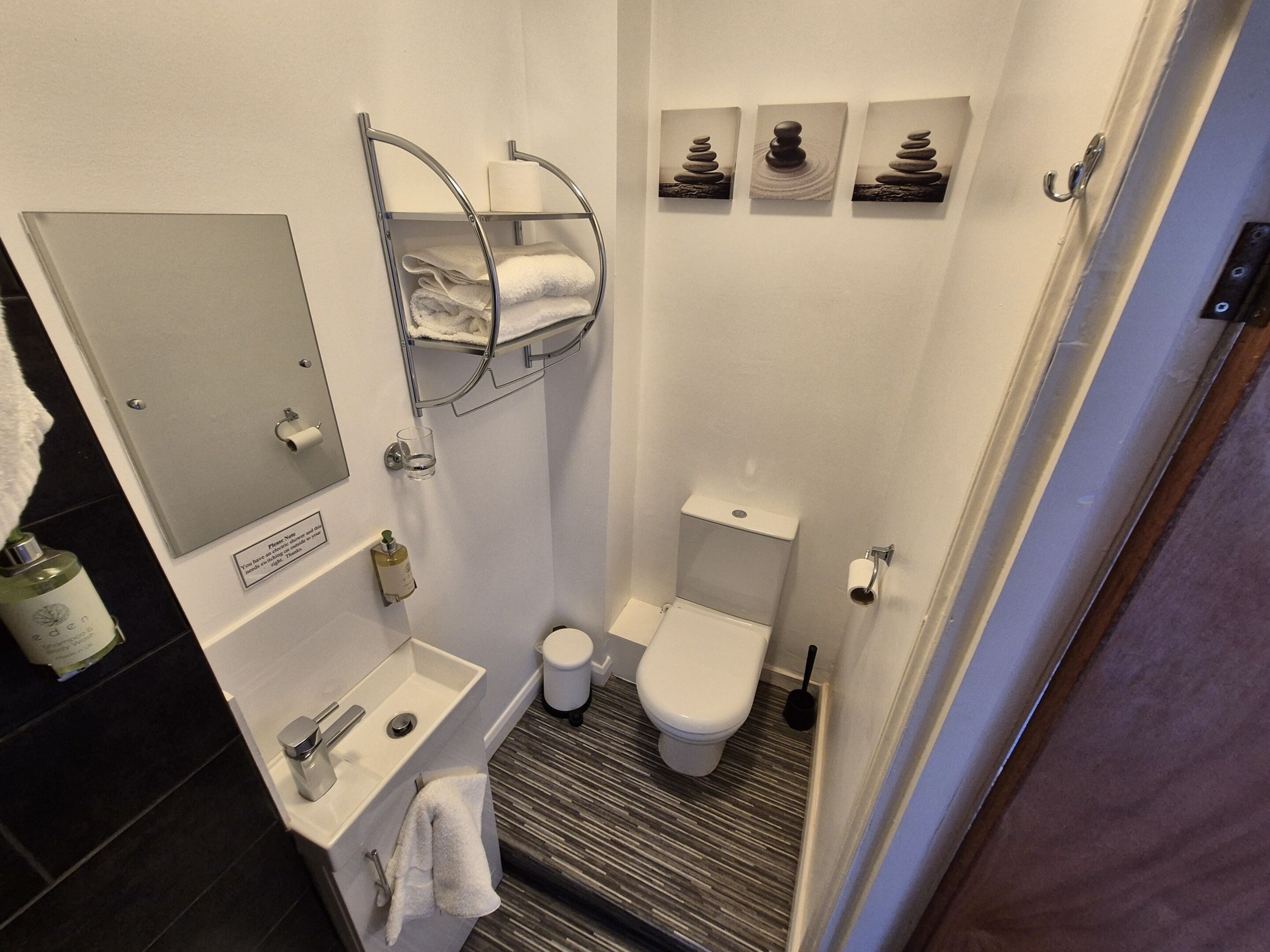 Une petite salle de bain comprenant des toilettes, un lavabo et un porte-serviettes.
