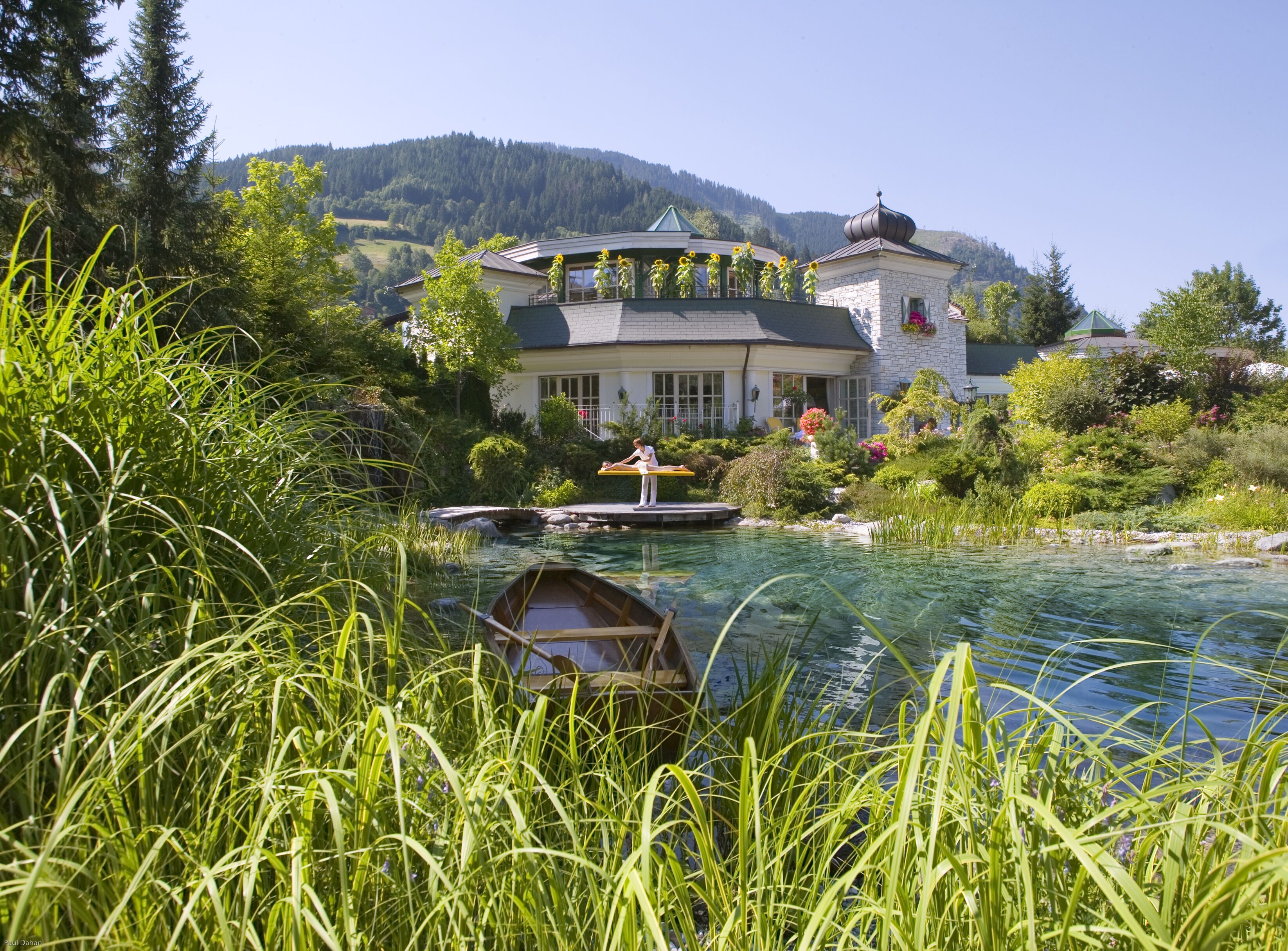 A house with a garden and a pond.