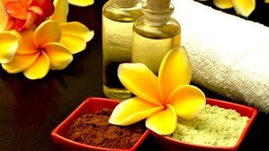 Two glass bottles with cork stoppers, a white towel, and two red bowls containing different powders. - ibis Styles Bali Denpasar (Denpasar)