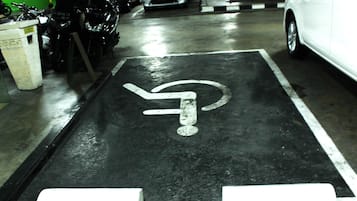 A parking space marked with a wheelchair symbol, indicating accessibility.