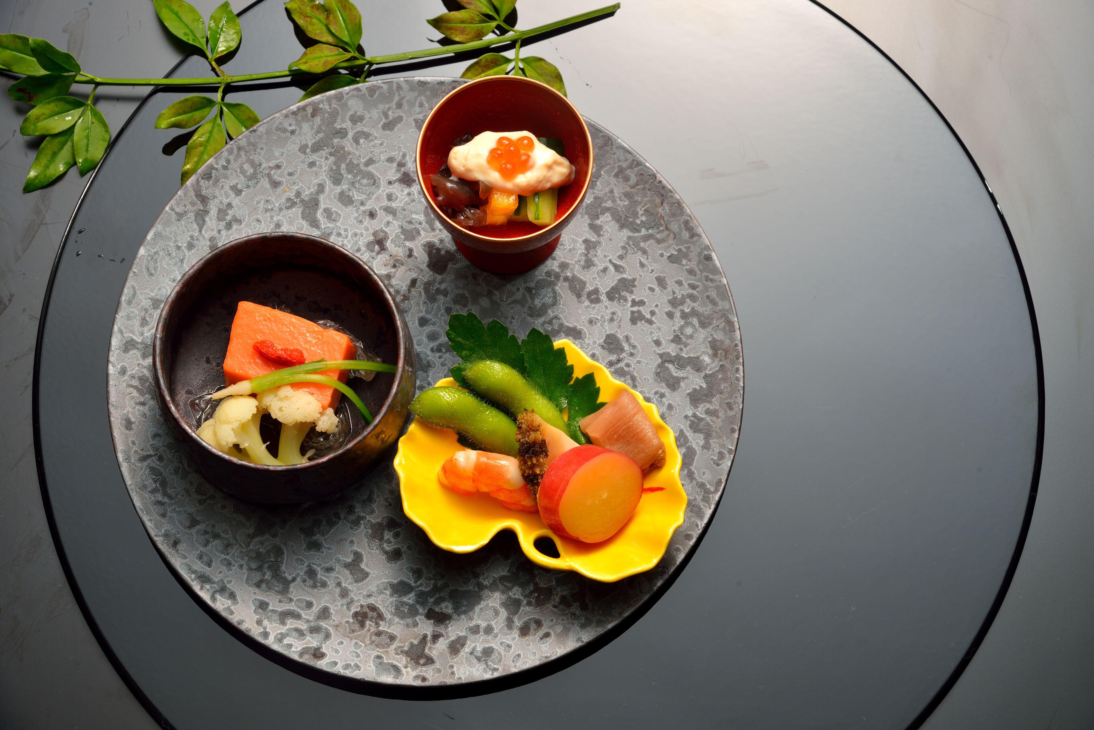 A table with three bowls of food, each containing different ingredients.
