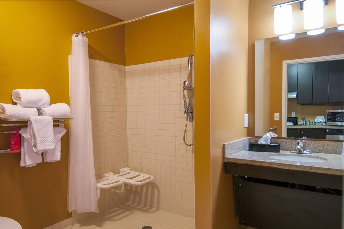 A bathroom with a shower, toilet, and sink.