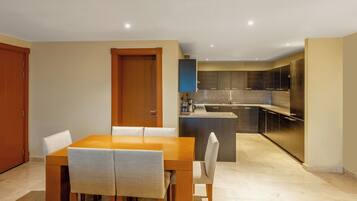A modern kitchen with dark cabinets, a granite countertop, and a built-in oven.