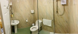 A bathroom with a sink, toilet, and shower.