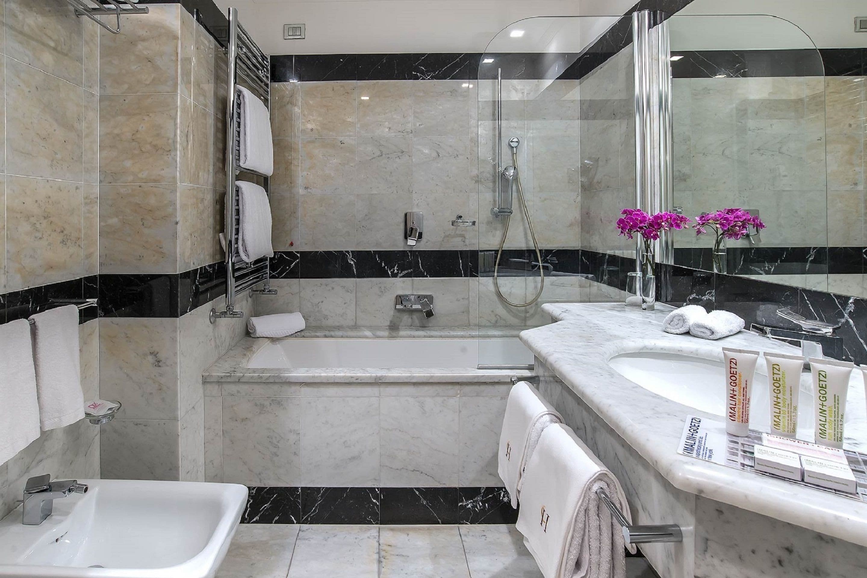 designer toiletries, hair dryer, bathrobes, slippers