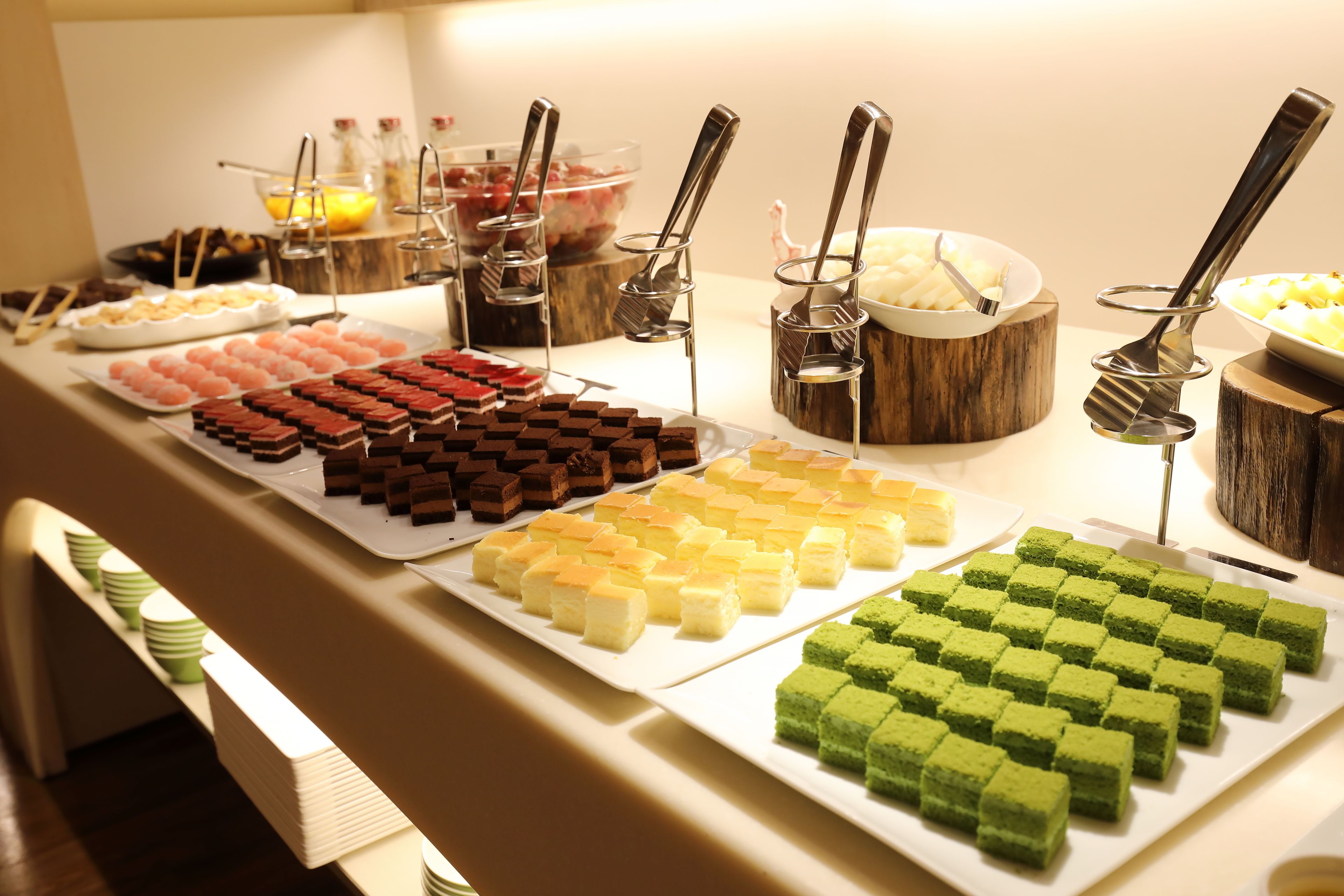 A buffet with various desserts and beverages.