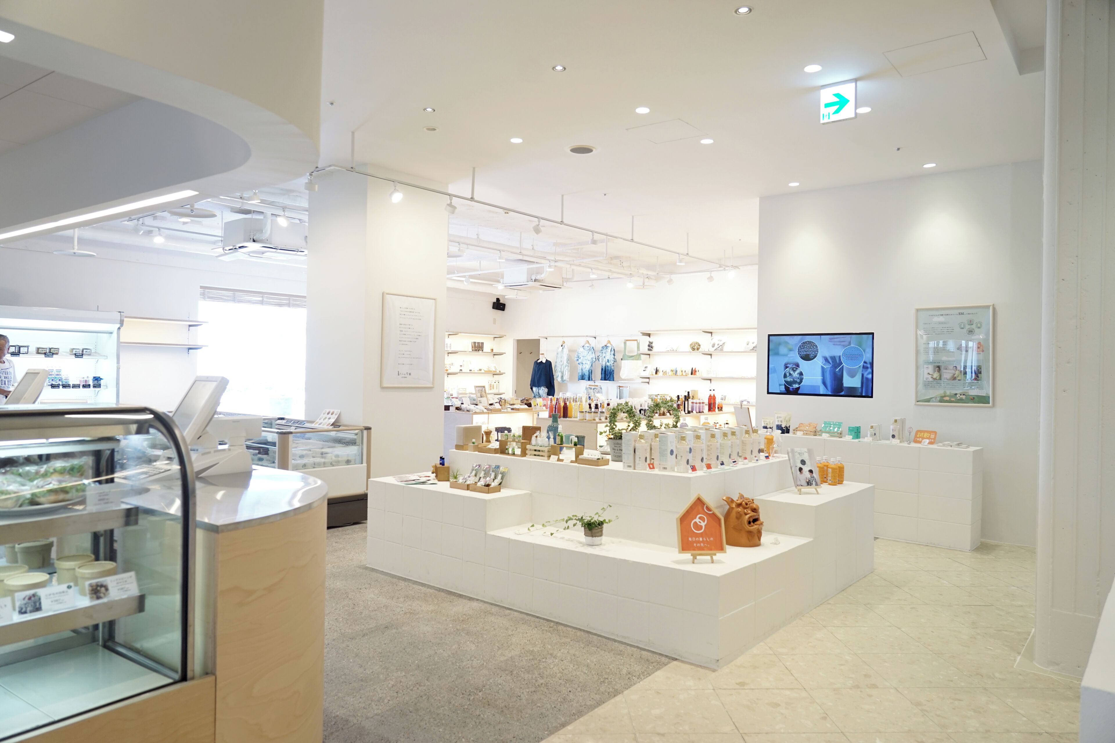 A modern, well-lit retail space with a variety of products displayed on shelves and counters.