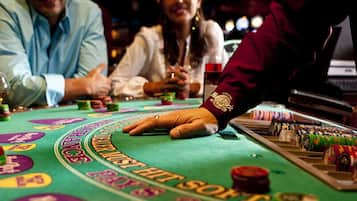 A blackjack table with chips and cards.