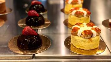 A dessert display with various cakes and pastries.