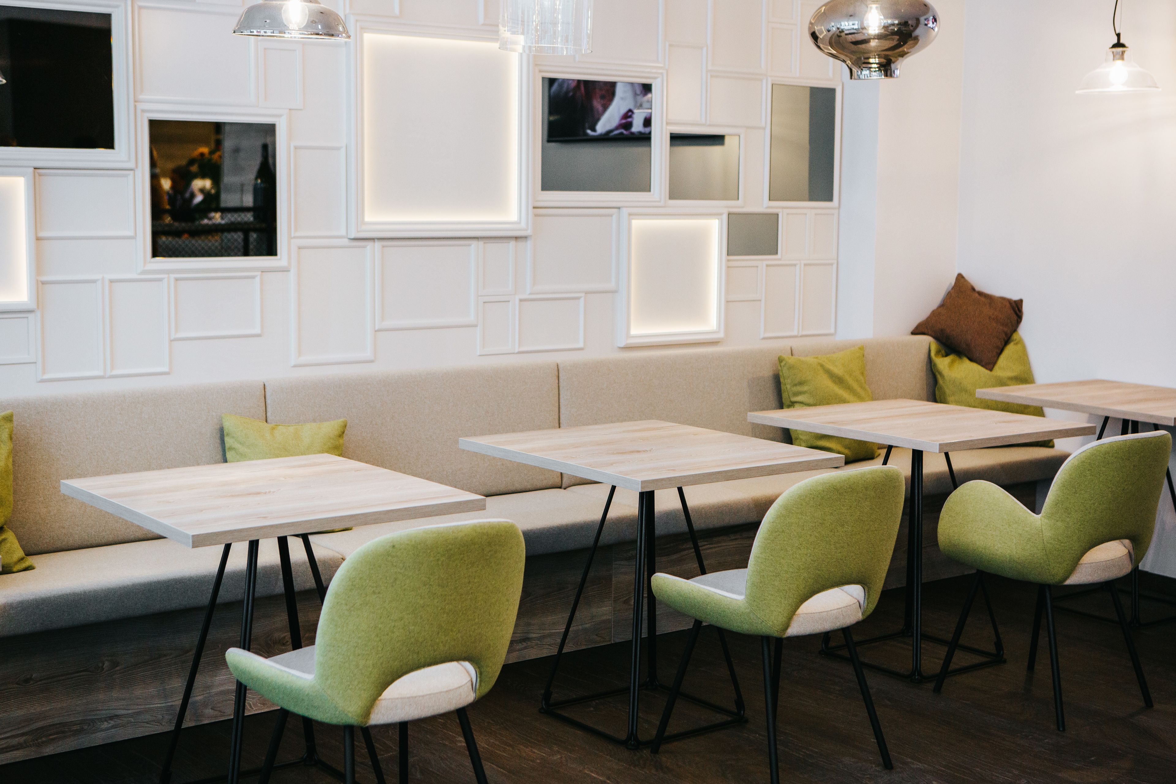 A modern interior with a sofa, tables, and chairs.