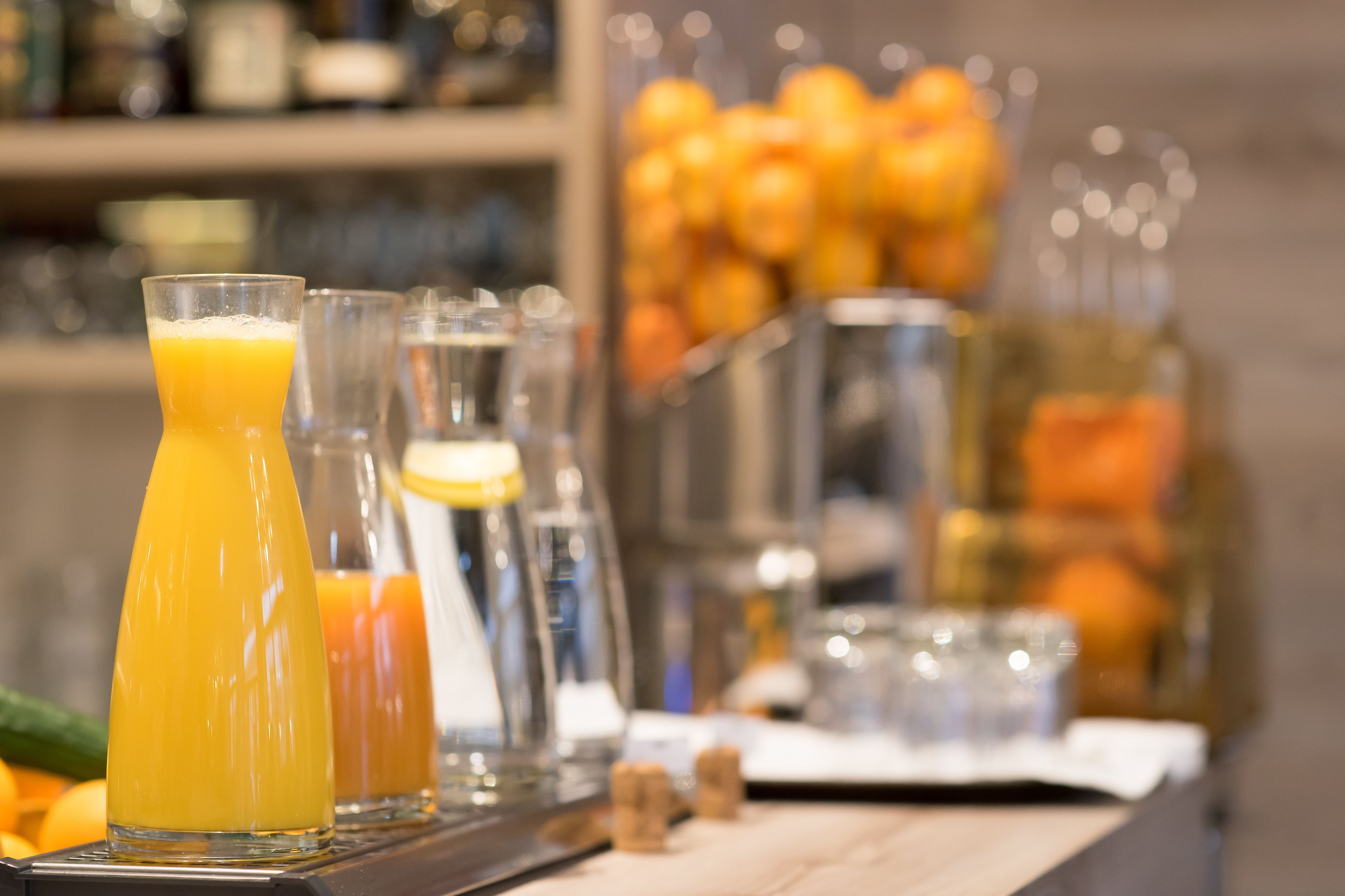 A bar area with various beverages and a fruit display.