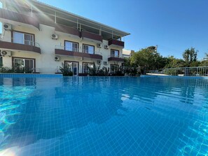 Seasonal outdoor pool, pool umbrellas, pool loungers