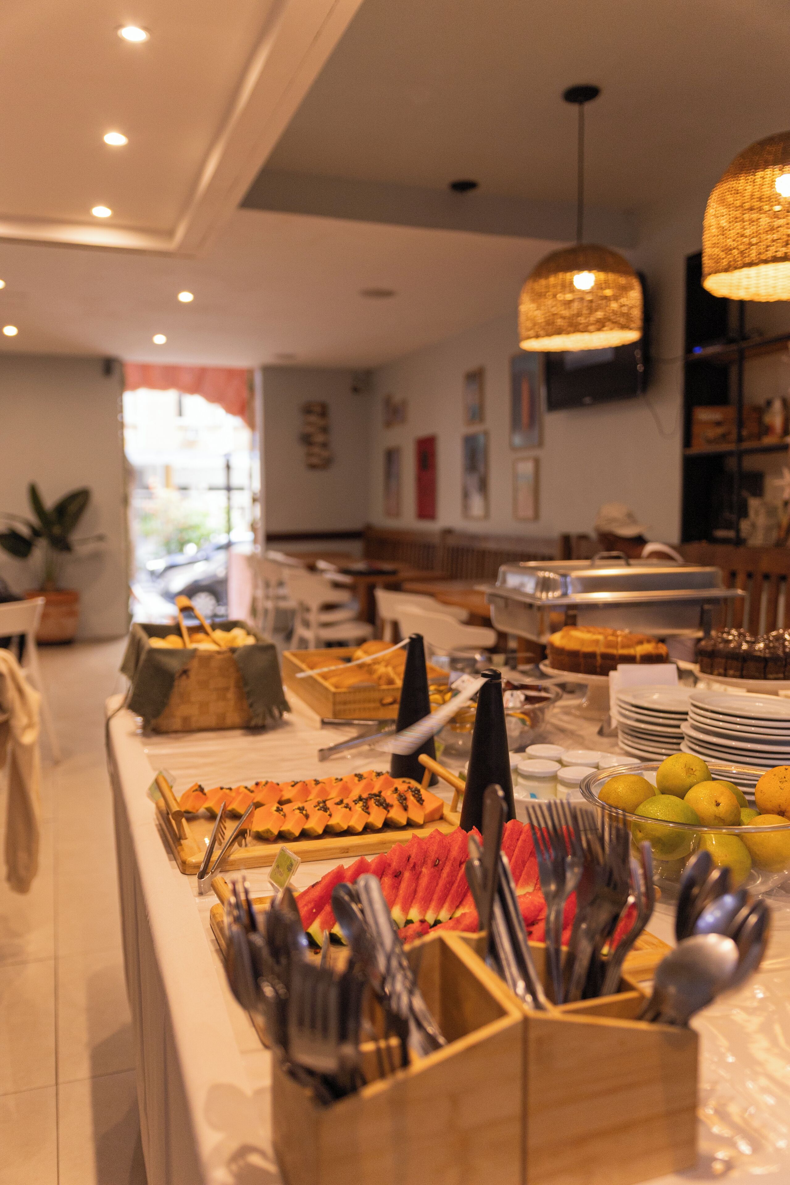 A buffet setup with various food items and utensils.