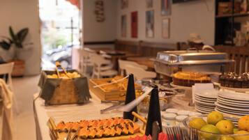 A buffet setup with various food items and utensils.