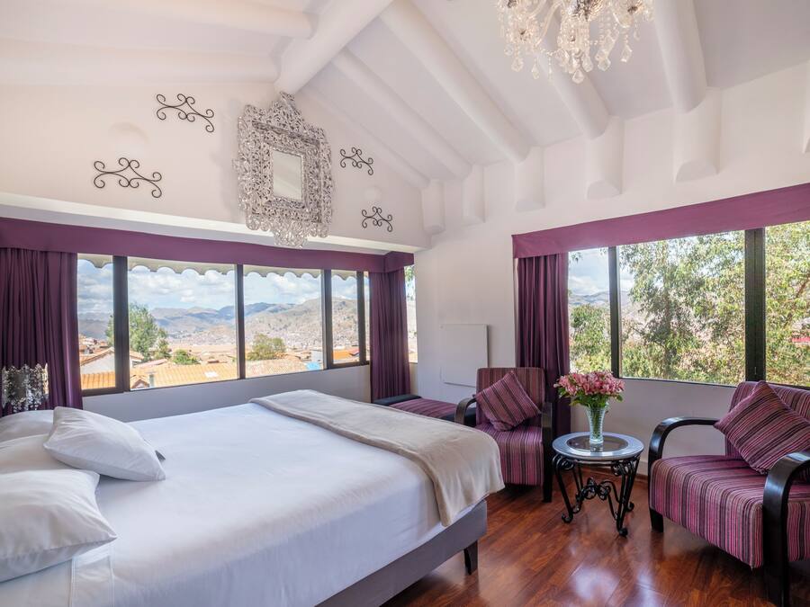 Deluxe Suite, City View | Down comforters, in-room safe, individually decorated, blackout drapes