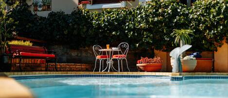 Outdoor pool, open 7:00 AM to 7:00 PM, sun loungers