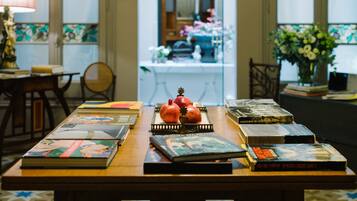 A table with books and a pomegranate centerpiece.