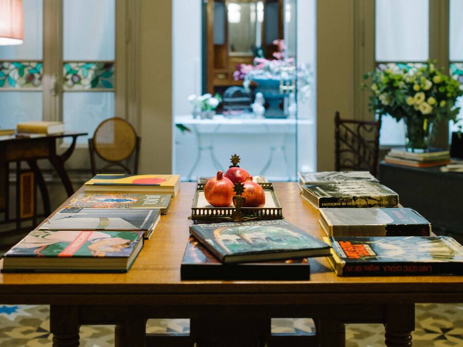 A table with books and a pomegranate centerpiece.
