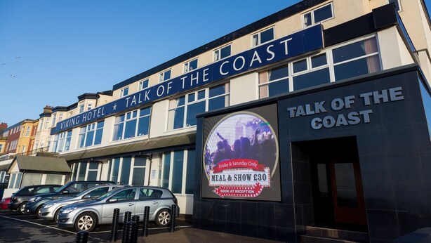 A building with a sign that reads "Viking Hotel" and "Talk of the Coast." There is a poster advertising a meal and show for £30 on Fridays and Saturdays.