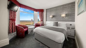 Desk, iron/ironing board, bed sheets