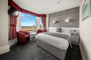 Desk, iron/ironing board, bed sheets