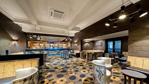 A bar area with seating and a patterned floor.
