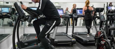 A gym with treadmills and exercise equipment.