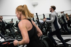 A gym with multiple treadmills and mirrors on the walls.