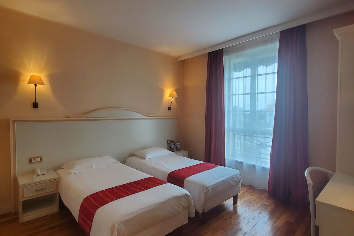 classic twin room, 2 single beds | premium bedding, desk, laptop workspace, blackout curtains