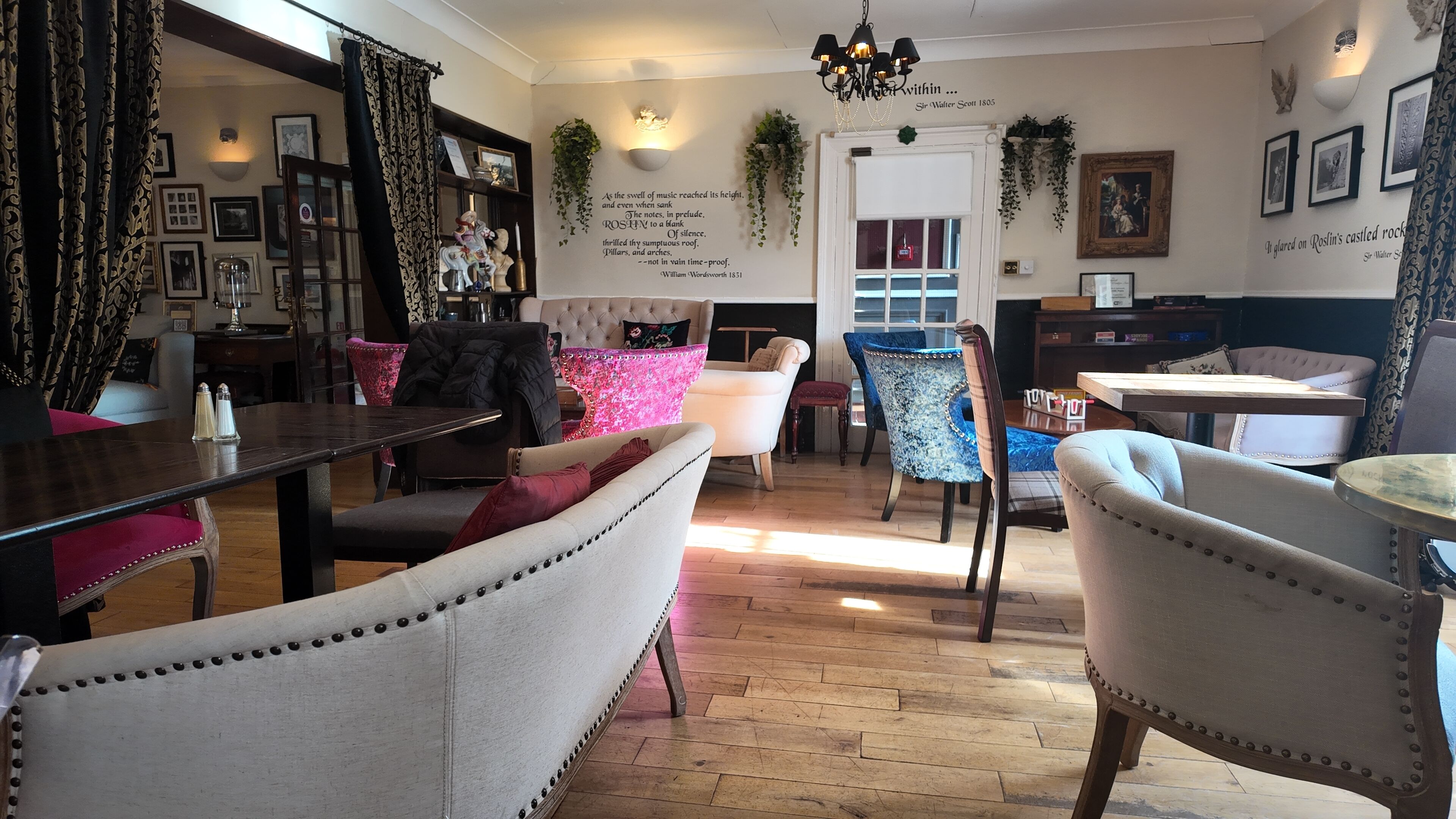 A cozy room with a fireplace, a dining area with a table and chairs, and a seating area with sofas and armchairs.