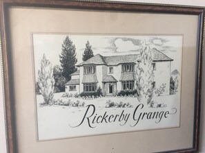 A framed black and white illustration of a house with the text "Rickerby Grange" below it.