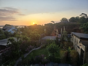 A residential area with houses, a garden, and a sunset. - Two Beaches (Paignton)