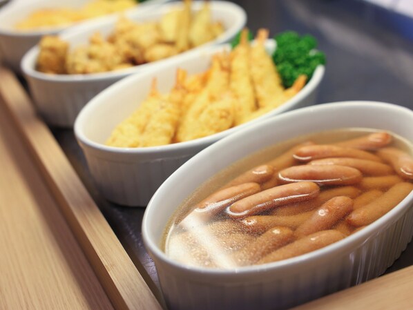Three bowls of food, likely containing different dishes, arranged on a tray.