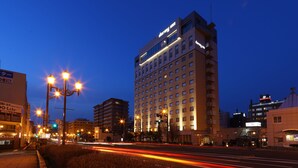 A high-rise hotel with multiple floors and a prominent sign at the top. - Natural Hot Spring Dormy Inn Premium Kushiro (Kushiro)