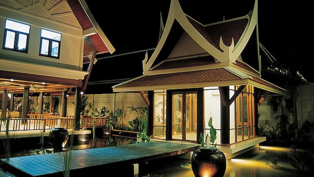 A traditional Thai house with a tiled roof, a wooden deck, and a water feature. - Kata Poolside Resort (Karon)