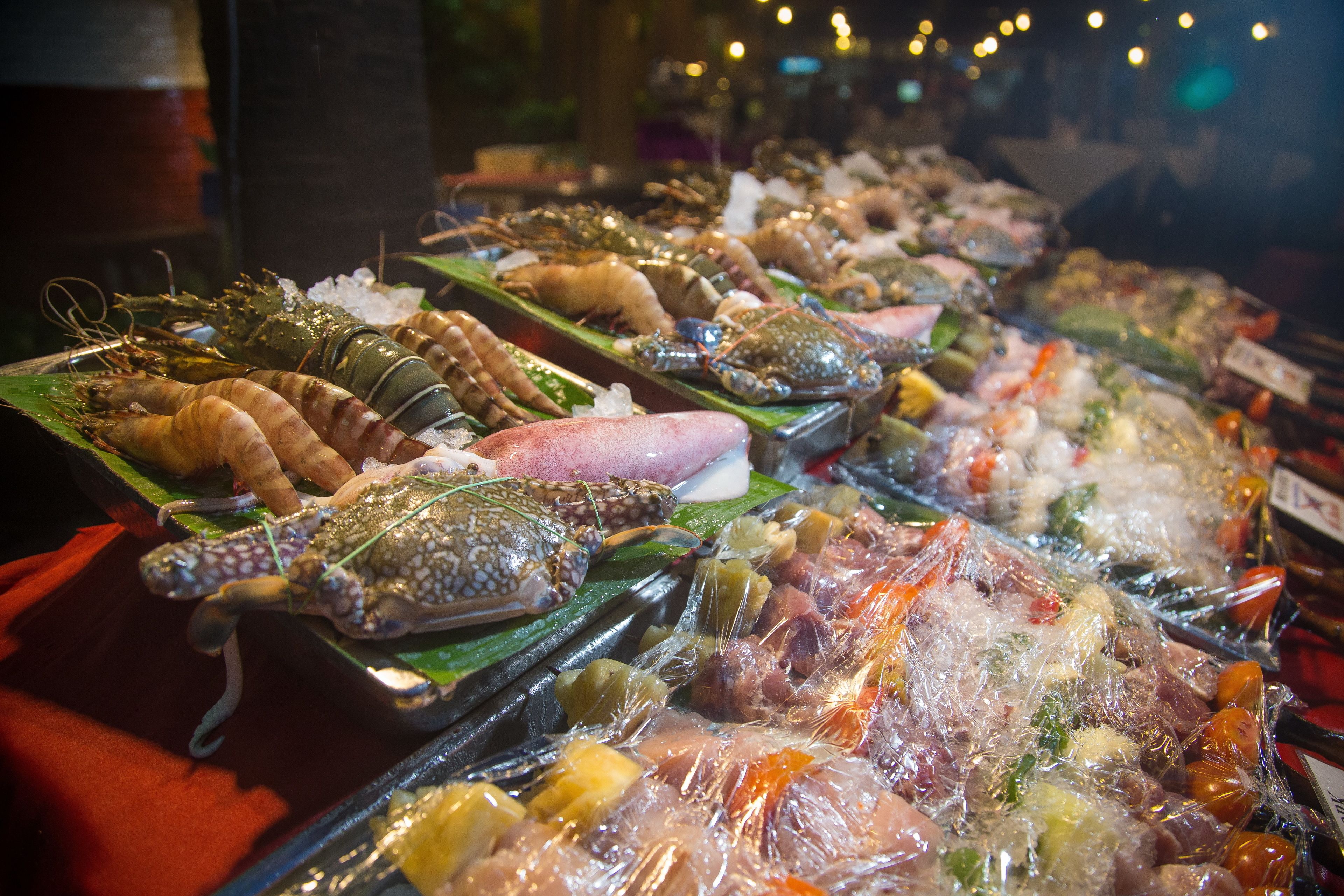 A seafood display with various types of shellfish and seafood on ice.
