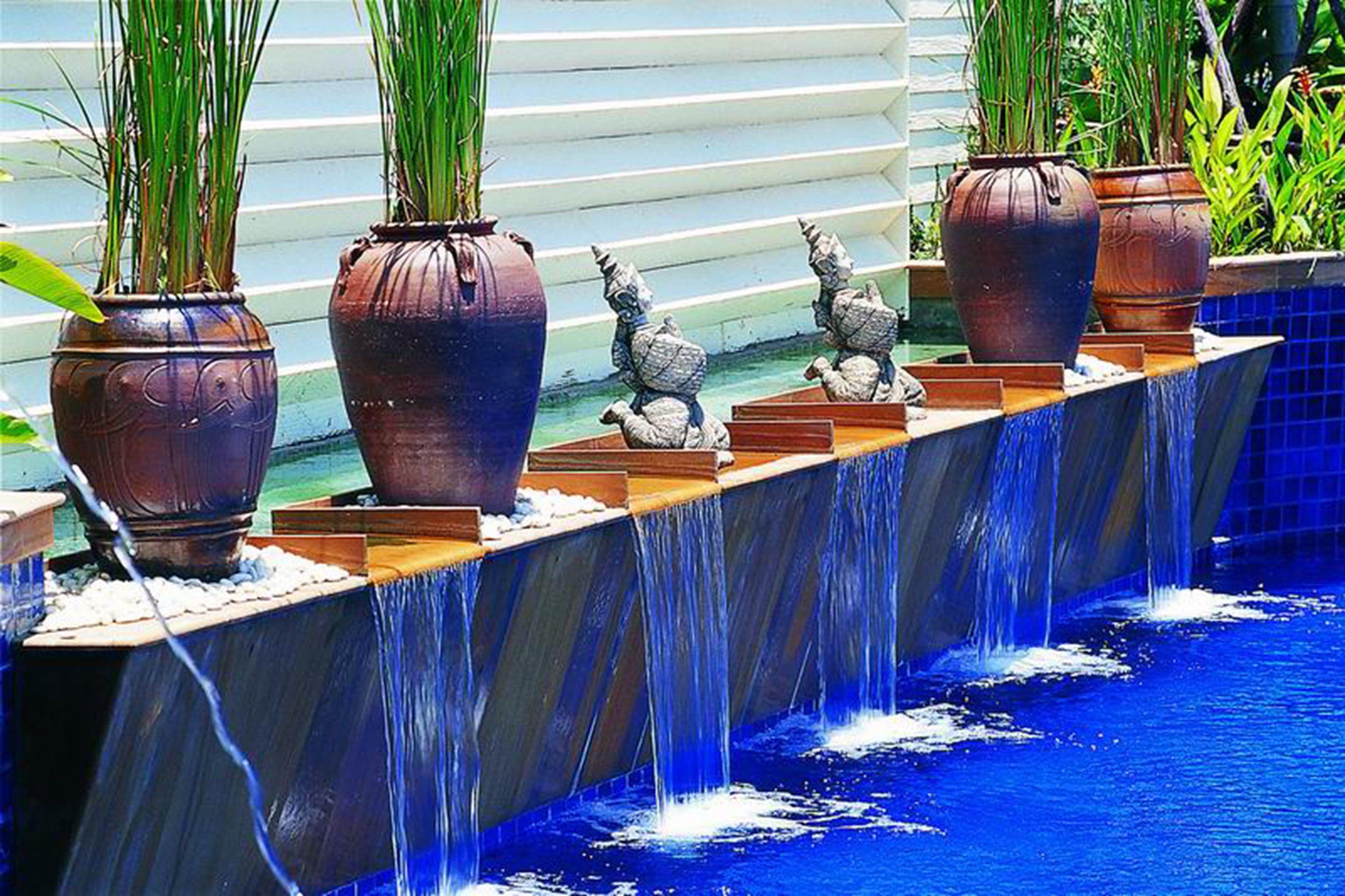 A water feature with multiple planters and decorative elements.