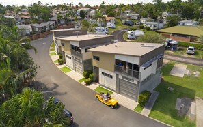 A modern two-story building with a flat roof and a balcony on the second floor. - Brisbane Holiday Village (Eight Mile Plains)