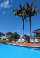 Outdoor pool, open 8:00 AM to 8:00 PM, pool loungers