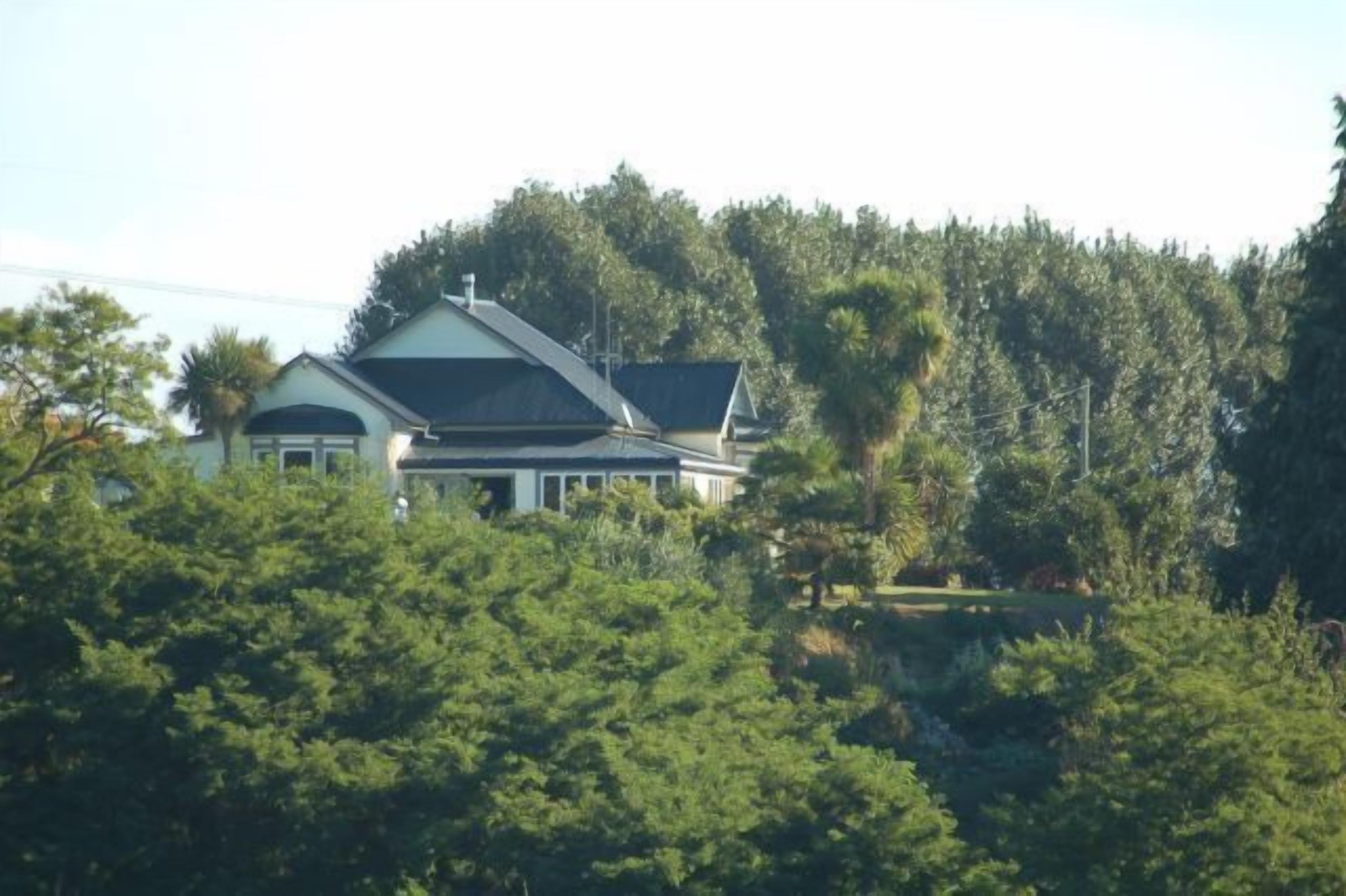 A house surrounded by dense trees.